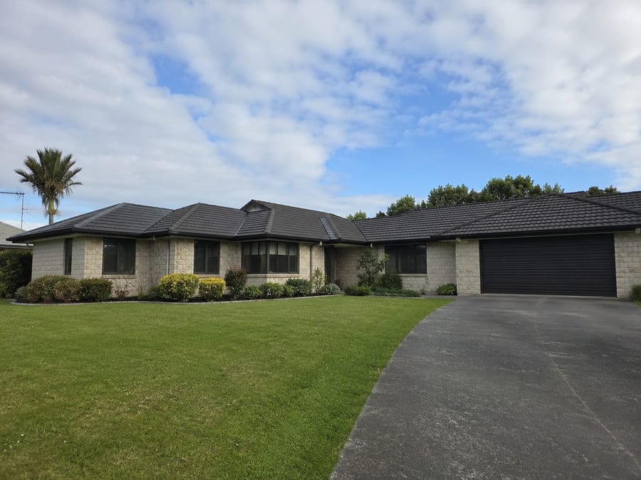 Wide single-storey Auckland home with a long roofline and attached garage